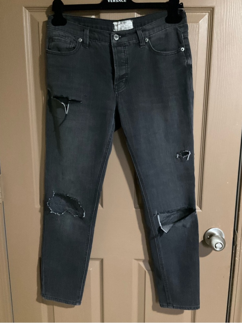Free People size 27 black buttonfly jeans, distressed with fishnet patching
